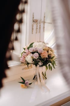 The bride's wedding bouquet of fresh pink flowers and a boutagniere. Wedding Details.