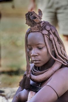 May 15, 2005. portrait of unidentified Himba woman with the traditional hairstyle, necklace and the typical ochre tinted skin. Epupa Falls, Kaokoland or Kunene Province, Namibia, Africa