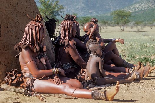 May 15, 2005. Himba women do not identify their children with traditional hairstyle, necklace and typical ocher skin. Epupa Falls, Kaokoland or Kunene Province, Namibia, Africa
