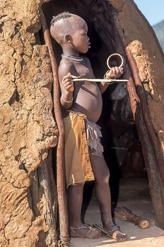 May 15, 2005. unidentified himba boy in the traditional hut, Epupa Falls, Kaokoland or Kunene Province, Namibia, Africa