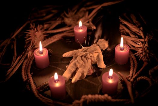 Pentagram amulet and black candle in autumn forest, natural background. Magic esoteric witches ritual. Mysticism, divination, wicca, occultism, witchcraft concept. Samhain sabbat
