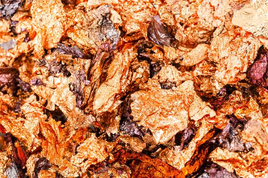 Background image of crumpled pieces of gold foil in close-up.Macrophotography.