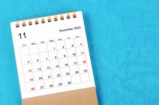 November 2023 Monthly desk calendar for 2023 year on blue background.