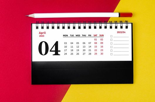 April 2023 Monthly desk calendar for 2023 year with white pencil on beautiful background.