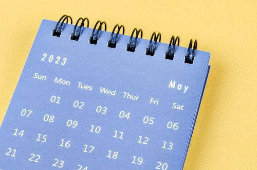 May 2023 Monthly desk calendar for 2023 year on yellow background.