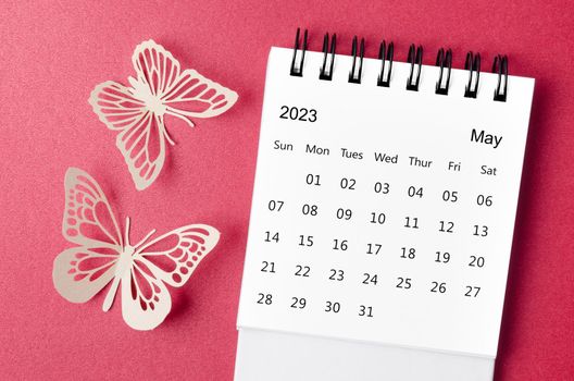May 2023 desk calendar for the organizer to plan and reminder with paer butterfly on red background.
