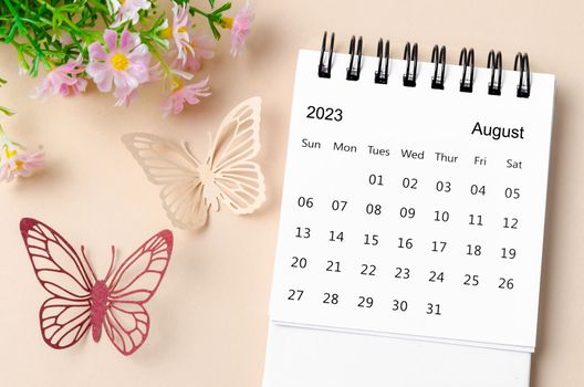 August 2023 desk calendar for the organizer to plan, reminder and butterfly paer with flower on yellow background.