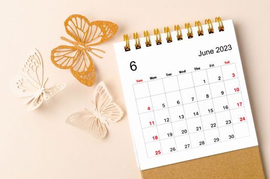 June 2023 desk calendar for the organizer to plan and reminder and butterfly paer on yellow background.