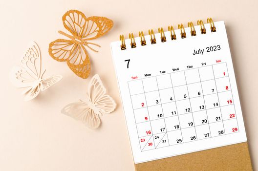 July 2023 desk calendar for the organizer to plan and reminder and butterfly paer on yellow background.