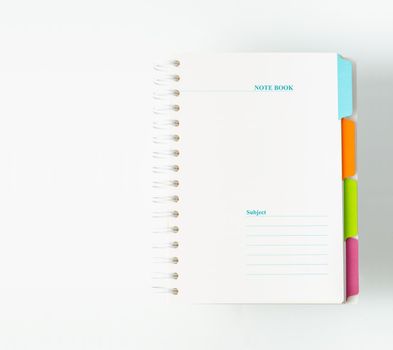 White notebooks with colourful index on white background, stationery.