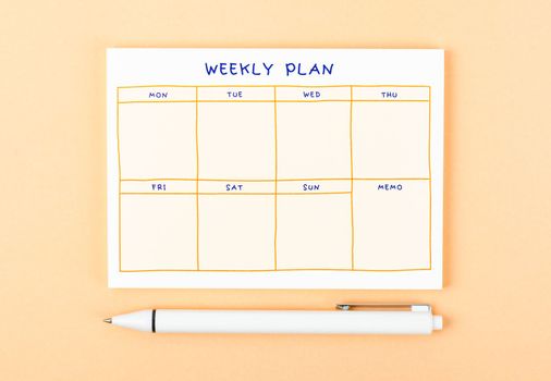 A Blank weekly plan notice block on yellow colour background. Empty schedule and a pen.