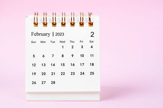 February 2023 desk calendar for 2023 year on pink color background.