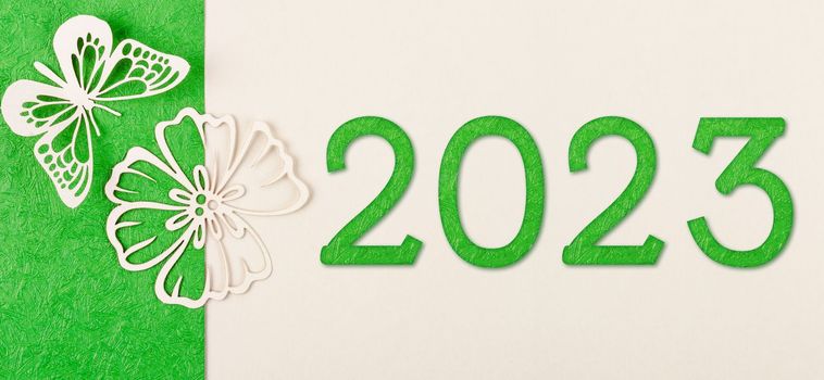 Green 2023 number and butterfly paper on greeting cards, holiday posters, and website headers. Environment 2023 concepts.