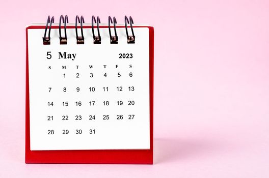 May 2023 desk calendar on pink color background.
