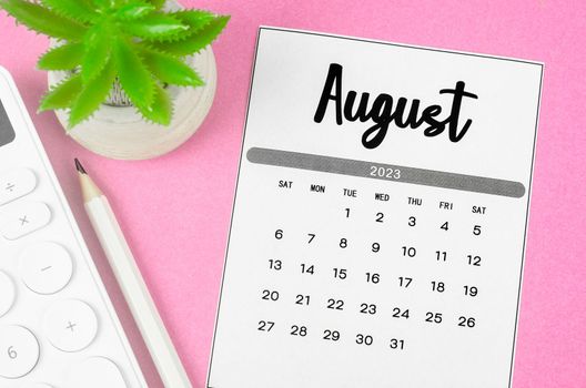 August 2023 Monthly calendar for 2023 year with calculator on pink background.
