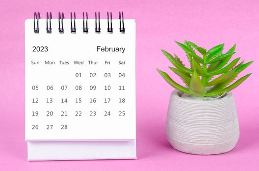 February 2023 desk calendar for 2023 on pink colour background.