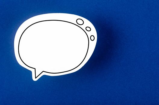 Speech bubble with copy space communication talking speaking concepts on blue background.