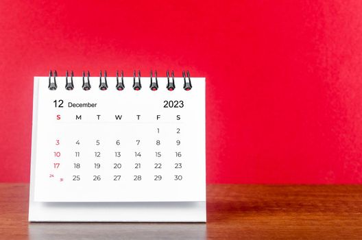 December 2023 desk calendar for 2023 year on Red color background.