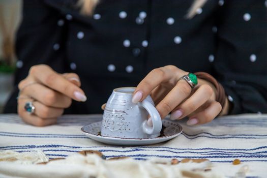 A fortune teller reads fortunes on coffee grounds. Selective focus. Woman.