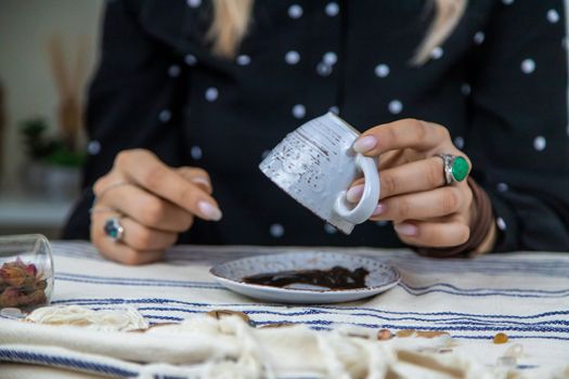 A fortune teller reads fortunes on coffee grounds. Selective focus. Woman.