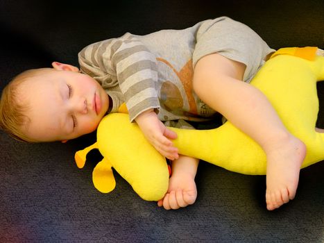 Cute little kid sleeping. Little boy sleeping in bed Cute little boy sleeping, tired child taking a nap in his small bed, clean, fresh and cozy bedding sheets, bedtime for kids. High quality photo