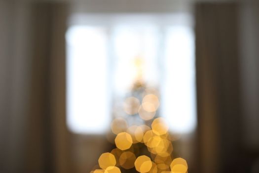 christmas background with christmas tree out of focus. abstract christmas background with defocused lights.