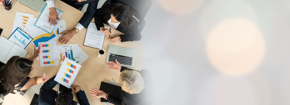 Business people group meeting shot from top widen view in office . Profession businesswomen, businessmen and office workers working in team conference with project planning document on meeting table .