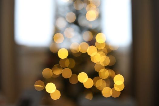christmas background with christmas tree out of focus. abstract christmas background with defocused lights.