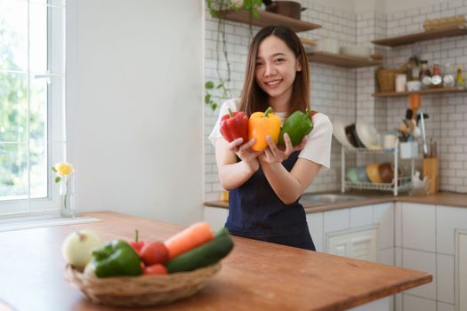 Portrait of beautiful young asian woman making salad at home. cooking food and Lifestyle moment.