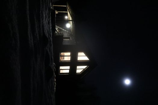 Old house in the forest at night. Old mystic building in night tree forest with moon