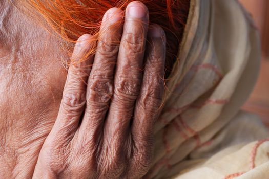 senior women having ear pain touching his painful ear 