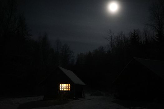 Old house in the forest at night. Old mystic building in night tree forest with moon