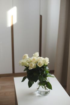 White rose bouquet in a cozy home interior. Floral spring or Valentines day romantic background, happy holiday on February 14, dating and love concept