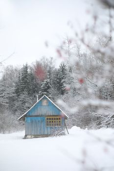 winter landscape panorama with wooden house in the forest. Snow covered hut. Christmas holiday and winter vacations concept.