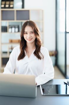 business owner or Asian female marketers are using tablet computer in office work.