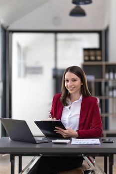 Business woman using calculator for do math finance on wooden desk in office and business working