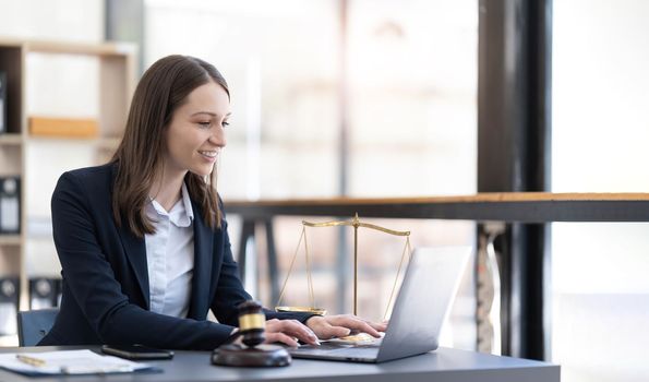 Business woman and lawyers discussing contract papers with brass scale on wooden desk in office. Law, legal services, advice, Justice and real estate concept...