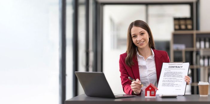 Portrait of a real estate agent or buyers are offering discounts on home insurance Sign a contract to buy and sell a house. Sign a contract. Signing concept...