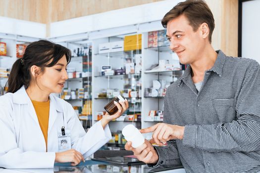 Professional pharmacist advise or explain property of qualified medical product to customer in pharmacy, druggist answer to client healthcare inquiry, medical service and consultation concept.