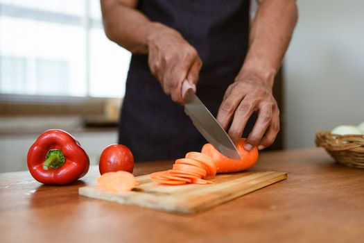 Portrait of asian man making salad at home. cooking food and Lifestyle moment.