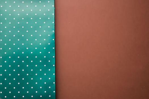 Abstract green polka dot background on brown backdrop.