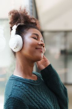 Young Black Woman Listening To Music Online Wearing Wireless Earphones, Enjoying Favorite Song. Playlist, Music Application.