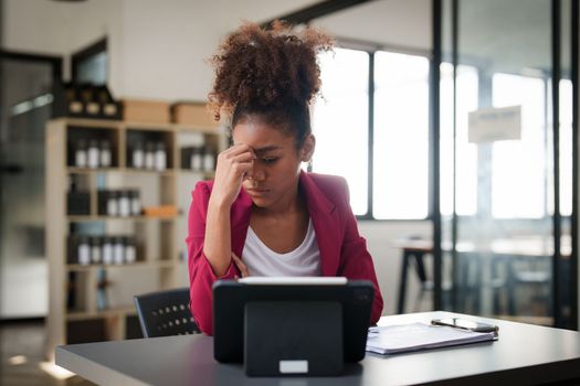 Portrait thoughtful confused young african american businesswoman looking at laptop. Stress while reading news, report or email. Online problem, finance mistake, troubleshooting.