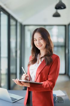 business owner or Asian female marketers are using tablet computer in office work.