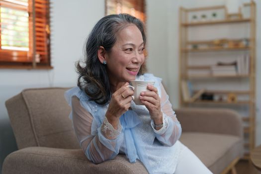 Senior woman good healthy drinking tea or coffee at home. Exercise and healthy diet concept.