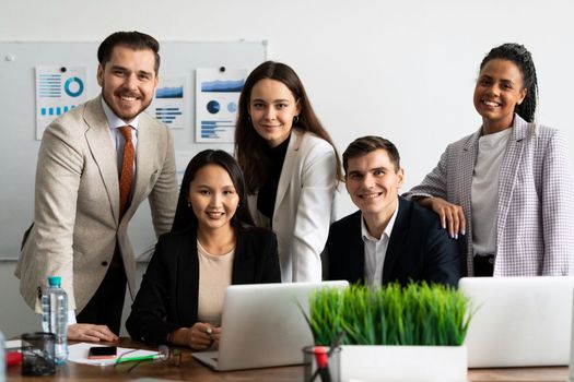 team of young business people smiling looking at camera at workplace.