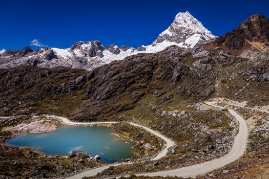 Turquoise Llanganuco lake in Cordillera Blanca at sunny day, snowcapped Andes, Ancash, Peru