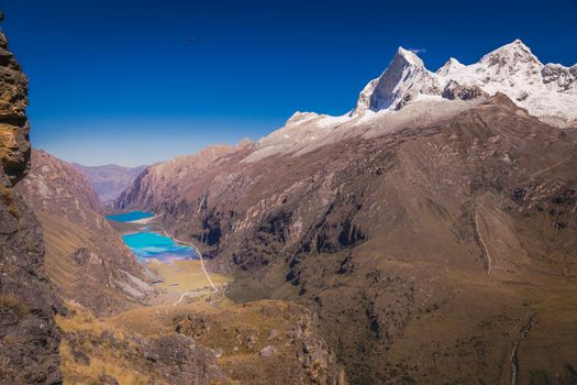 Turquoise Llanganuco lake in Cordillera Blanca at sunny day, snowcapped Andes, Ancash, Peru
