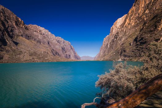 Turquoise Llanganuco lake in Cordillera Blanca at sunny day, snowcapped Andes, Ancash, Peru