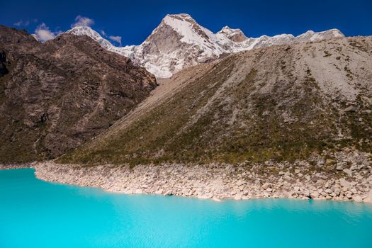 Turquoise Paron laguna in Cordillera Blanca at sunny day, snowcapped Andes, Ancash, Peru